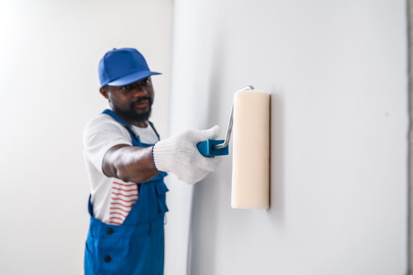 African-American Decorator Painting Wall